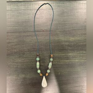 Handmade jade beaded necklace with teardrop-shaped pendant and accent beads.